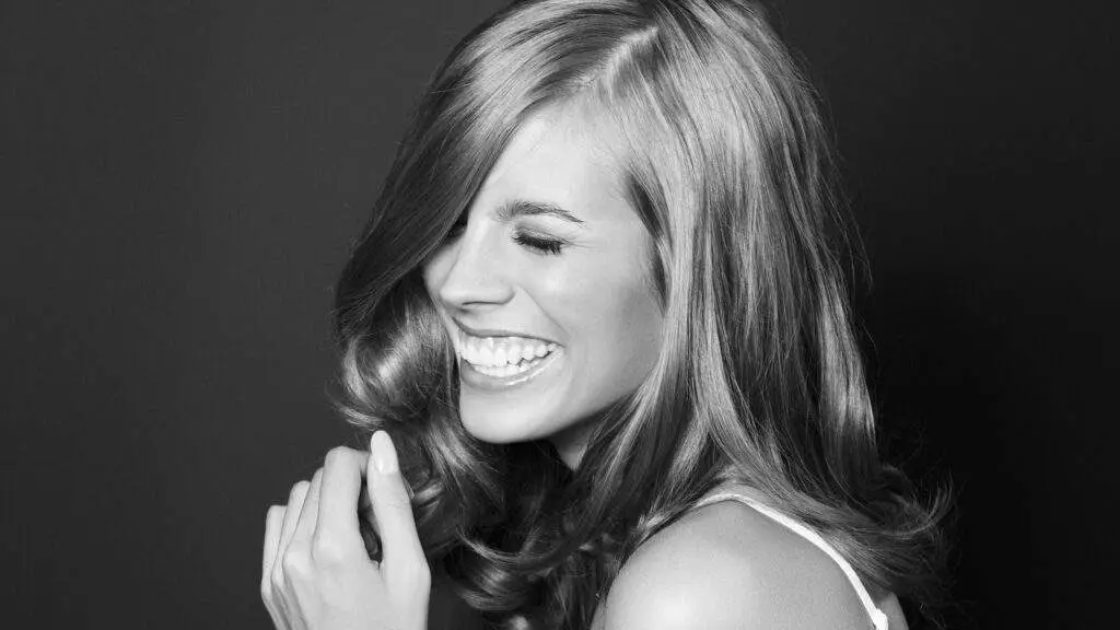 Hero Image Of Young Woman Laughing with a wide smile